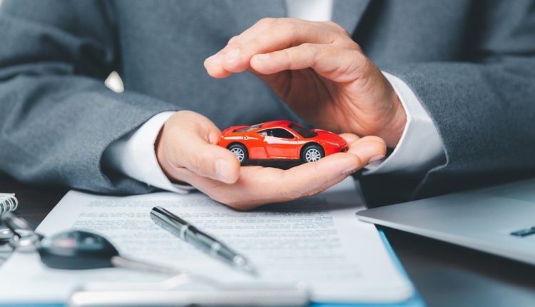 Driver with their car representing auto coverage confidence